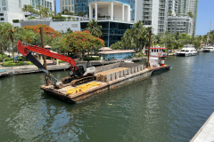 Tug Peggy Ann pushing material barge on New River